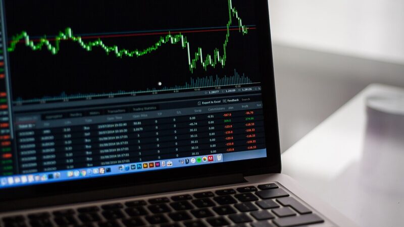 Blurred market data charts on screens