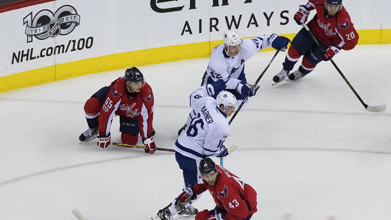 Players contesting the puck during an NHL game