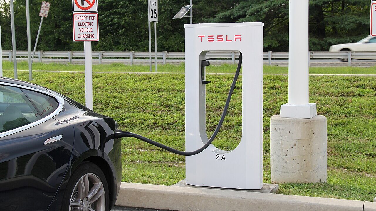 An electric car plugged in at a charging point