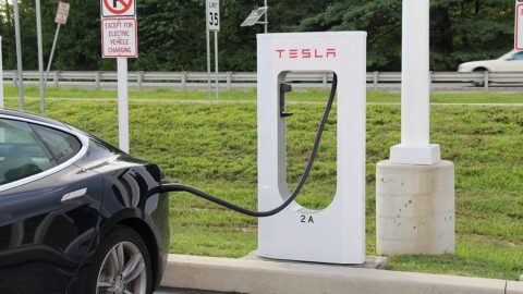 An electric car plugged in at a charging point