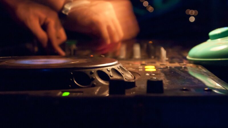 A DJ playing music on turntables at a club