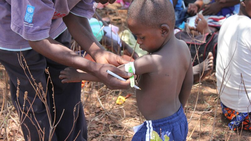 A village health worker checking on a family in Zimbabwe