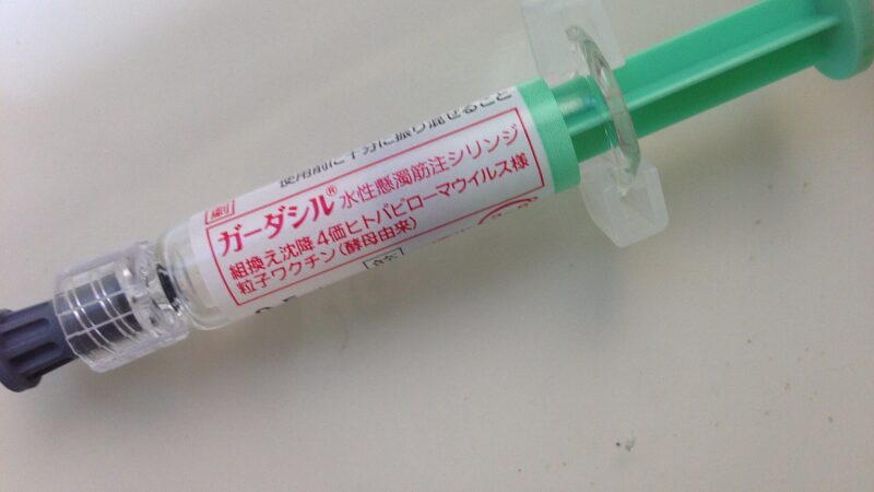 A vaccine vial and syringe being prepared for administration