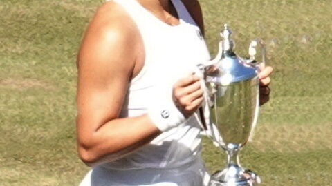 Chinese tennis player Guo Hanyu holding the Wimbledon doubles trophy