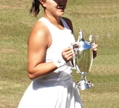 Chinese tennis player Guo Hanyu holding the Wimbledon doubles trophy