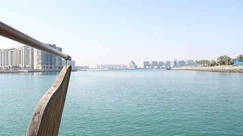 Abu Dhabi skyline viewed across calm water from a boat