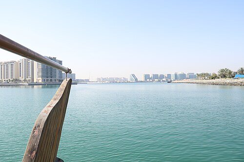Abu Dhabi skyline viewed across calm water from a boat